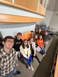 Selfie of 8 students with organ.